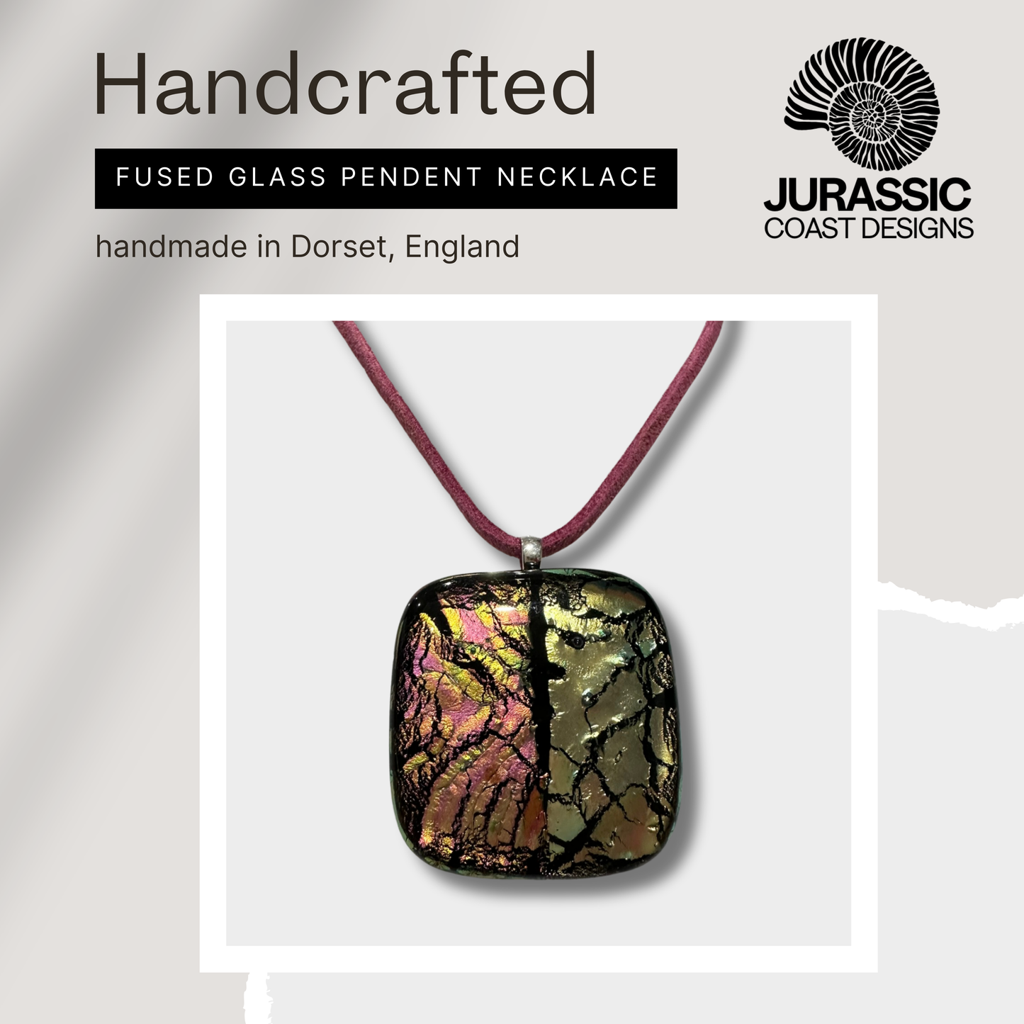Handcrafted fused glass pendant necklace on a white background with 'Jurassic Coast Designs' branding.