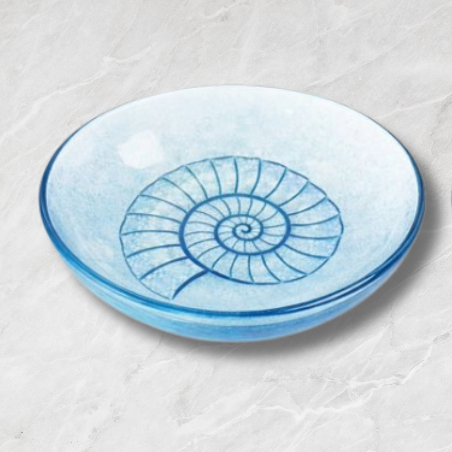 blue glass bowl with an ammonite design