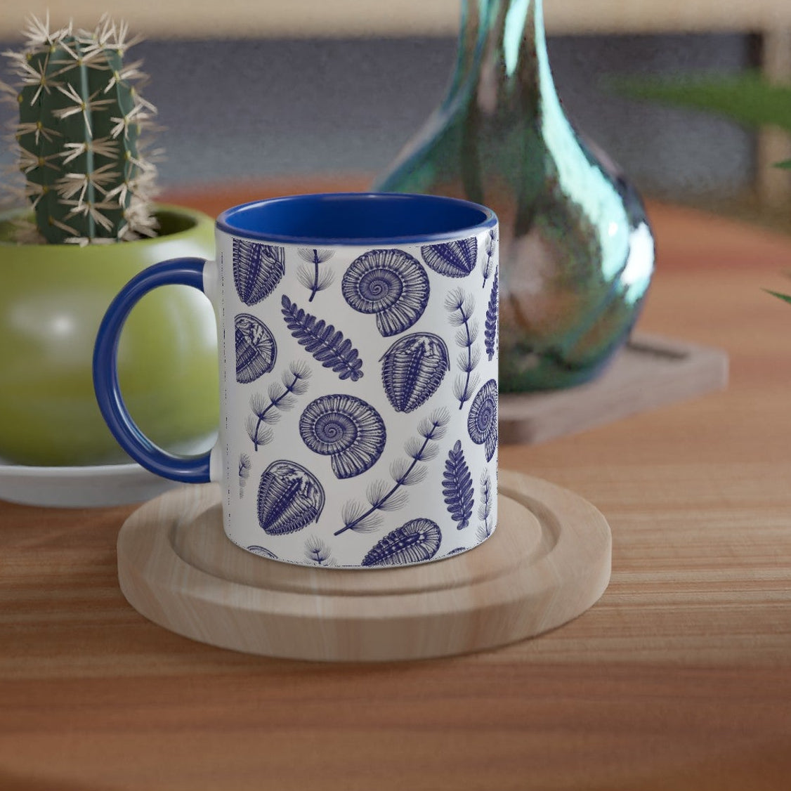 Mug with blue and white pattern on a wooden table with plants
