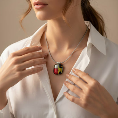 Woman wearing a necklace with a colorful pendant against a neutral background