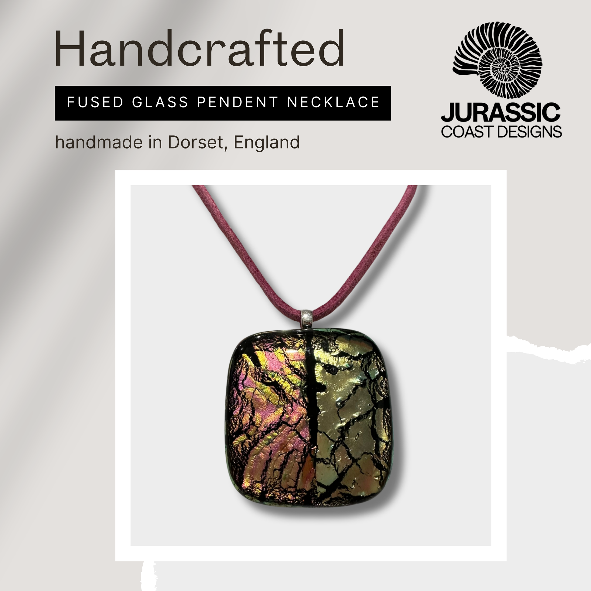 Handcrafted fused glass pendant necklace on a white background with 'Jurassic Coast Designs' branding.