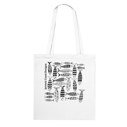 White tote bag with black fish pattern and 'Jurassic Coast Designs' text on a white background