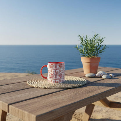Red mug and potted plant on a wooden table with ocean view