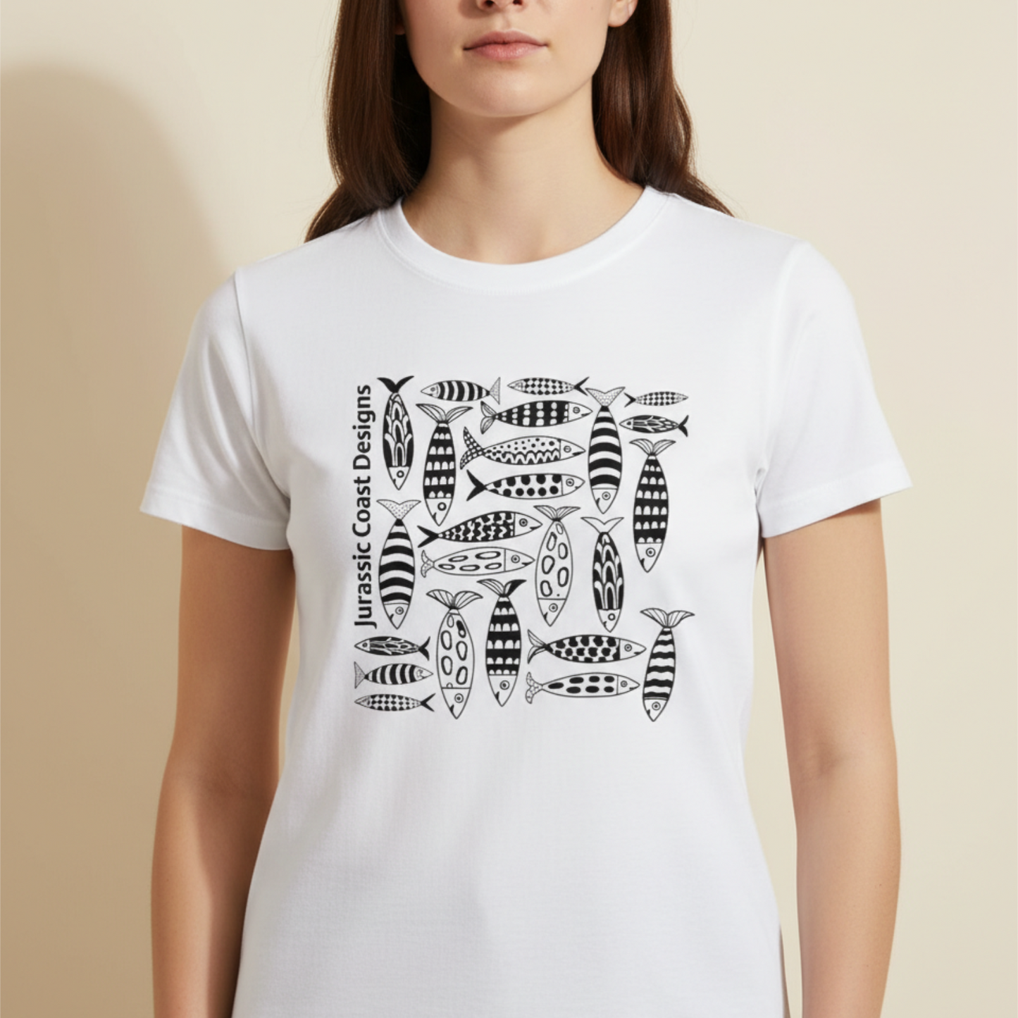 Person wearing a white t-shirt with black fish pattern design on a beige background