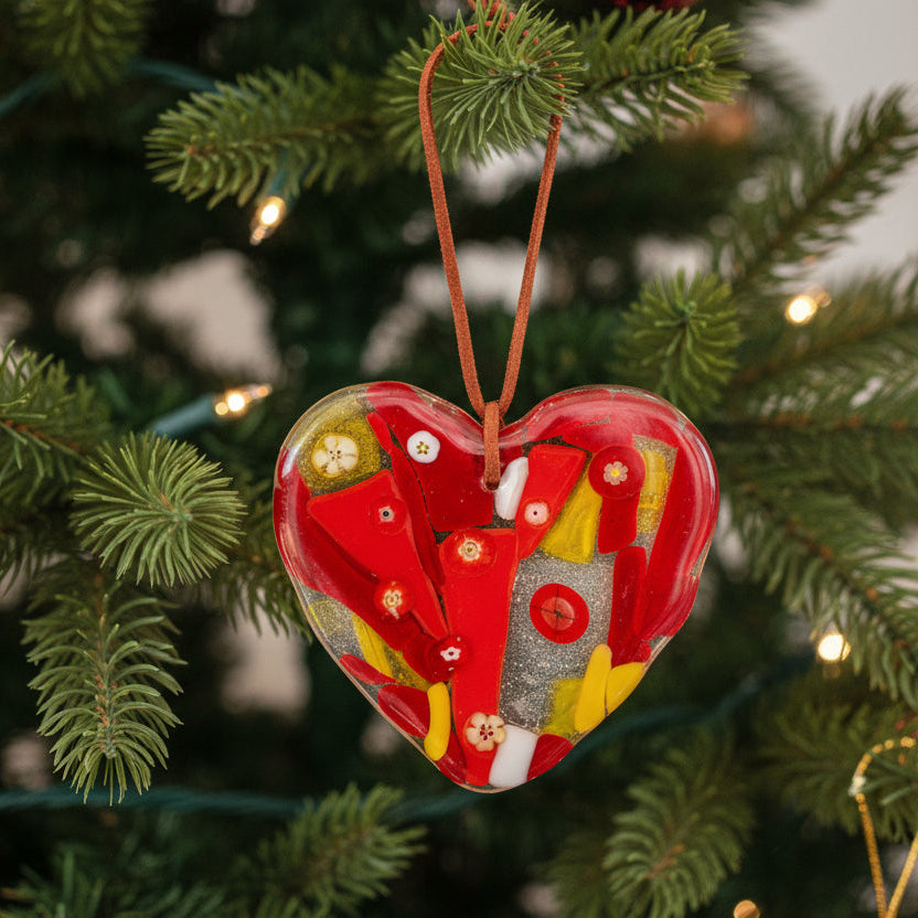 Heart-shaped pendant with red, yellow, and white design on a white background