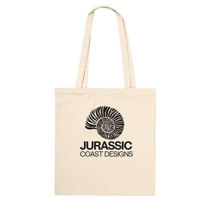 Beige tote bag with black 'Jurassic Coast Designs' logo on a white background
