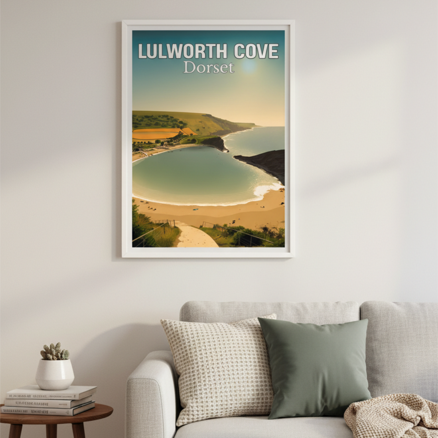 Framed artwork of Lulworth Cove, Dorset on a wall above a sofa.