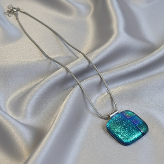 Blue glittery pendant with silk necklace