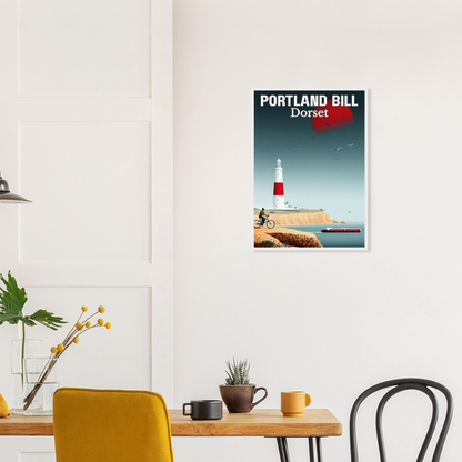 Framed poster of Portland Bill, Dorset on a wall above a table with decor items.
