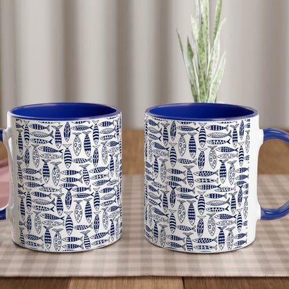 Two blue and white patterned mugs on a wooden table with a checkered tablecloth.