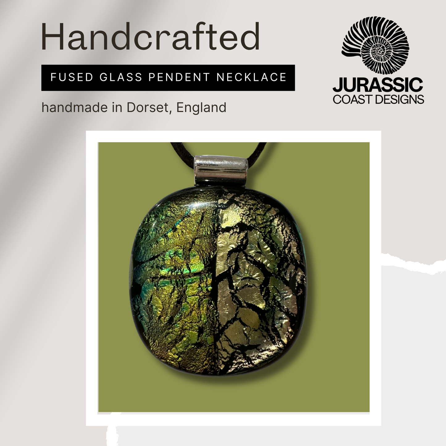 Handcrafted fused glass pendant necklace on a green background with 'Jurassic Coast Designs' branding.