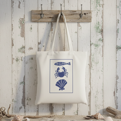 White tote bag with blue sea-themed graphics on a white background