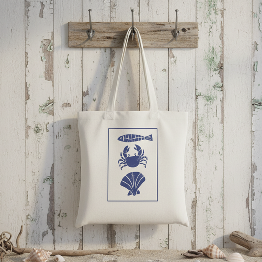 White tote bag with blue sea-themed graphics on a white background
