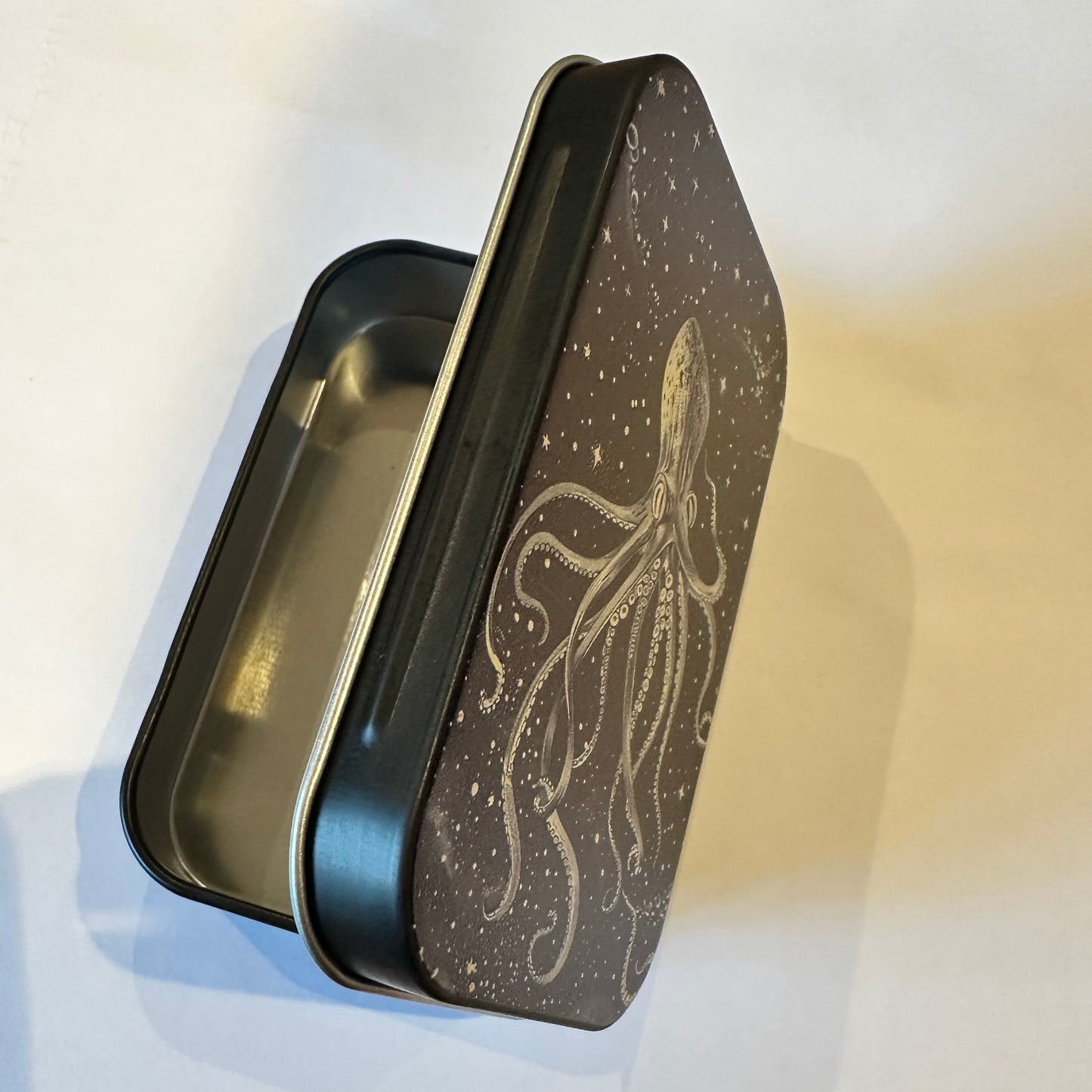 Rectangular metal container with a lid featuring an octopus design on a white background.