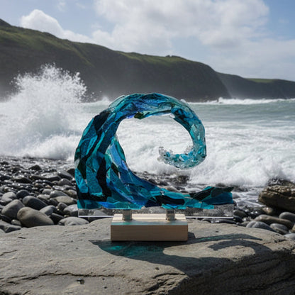 Blue glass sculpture on a white surface with a dark background
